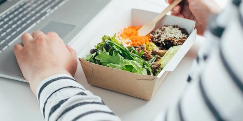 Woman,Having,Lunch,From,Recycled,Bowl,And,Using,Laptop.,Concept Woman,Having,Lunch,From,Recycled,Bowl,And,Using,Laptop.,Concept
